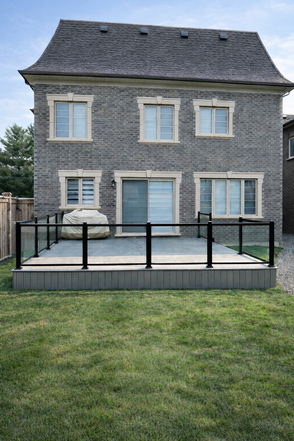 Beautiful custom multi-level deck with outdoor dining area and glass railings
