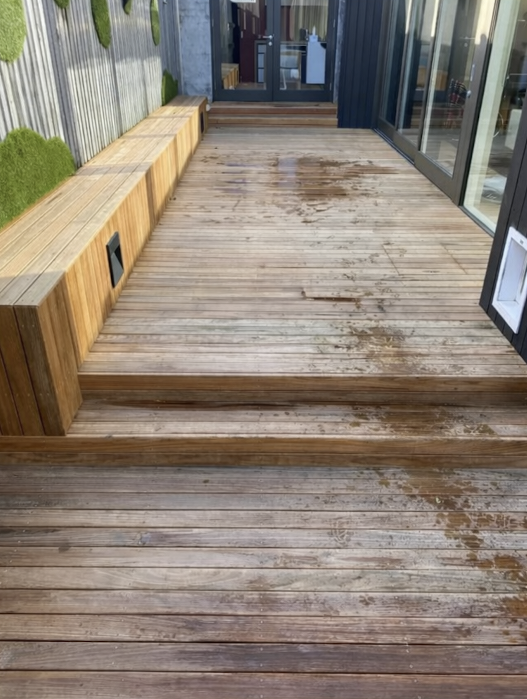 Weathered, grey, splintered deck boards before restoration